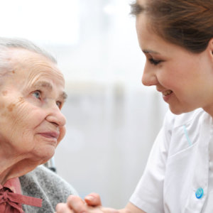 caregiver and senior woman smiling