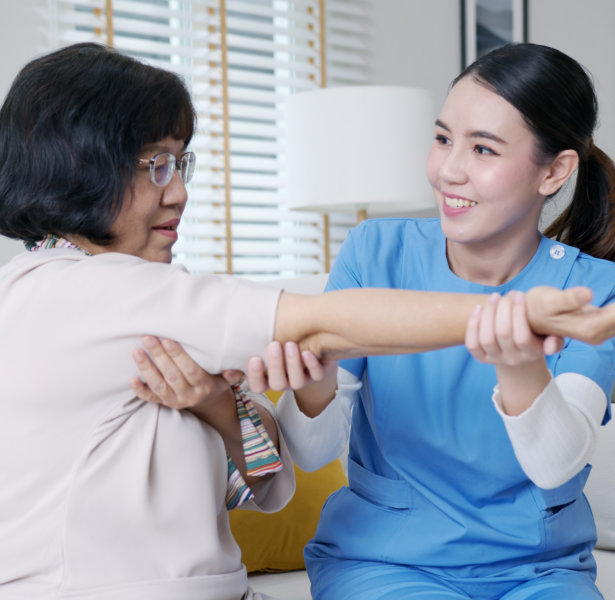 caregiver massaging senior arm