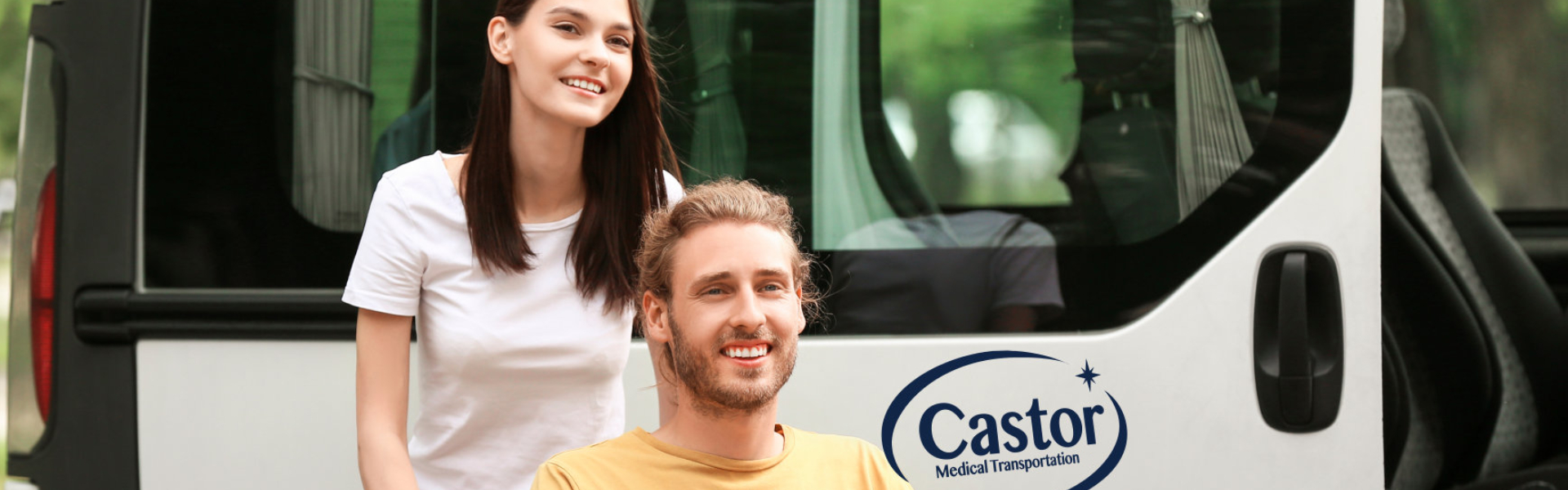 Smiling man on wheechair with young woman