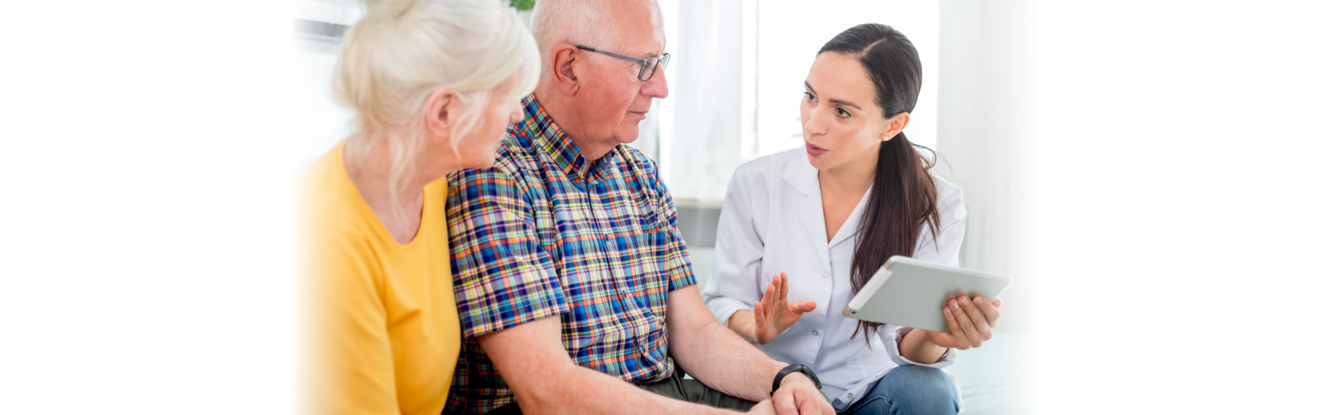 senior couple listening to caregiver